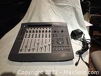 Front view of Command 8 control surface on white background with power supply