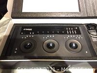 Front view of controller showing three optical trackballs and programmable keys
