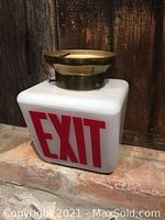 Front and side view of vintage white milk glass exit sign with red lettering and brass base.
