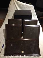 Five JBL in-wall speakers with black grill covers, four SP6 and one NT55 larger front center speaker, shown arranged in a group.