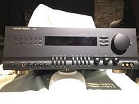 Front panel view of black Harmon Kardon AVR 25 receiver showing display, buttons, knobs and graphic equalizer sliders