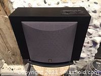 Front view of Yamaha powered subwoofer showing the black grille and compact square shape.