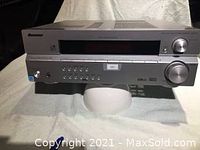 Front angled photo showing the full front panel of the silver Pioneer VSX-515 receiver including display, control buttons, and volume knob.