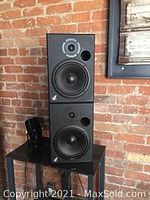 Front view of two black Event 2228 speakers stacked