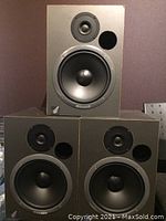 Front view showing three speakers stacked: two on bottom, one on top