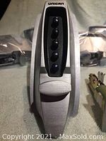 Close-up of a single Unican keyless door lock keypad and handle showing five black buttons on a silver metallic housing.