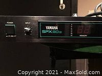 Front panel close-up showing power switch, input knob, model name and display