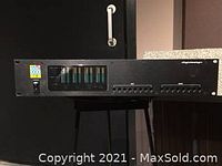 Front view of Digidesign 888 I/O showing power switch, logo, and LED signal level meters on black metal panel.