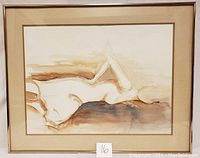 Front view of framed watercolor painting depicting a reclining nude figure in earthy tones.