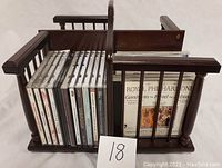 Wooden spinning CD rack side view showing approximately 12 CDs including Royal Philharmonic album