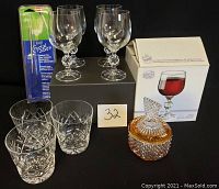 Lot overview showing four Bohemia crystal wine glasses, three cut-glass crystal tumblers, two-toned crystal covered dish, and Crystal Saver diamond file.