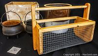 Full lot showing cast iron pots, wooden box, crock pot, wire carryall, and basket
