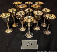 Thirteen Primrose Plate silver plated over copper wine goblets arranged on black surface with size number '40' displayed.