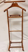 Full frontal photo of the walnut valet stand showing hanger and lower support bars
