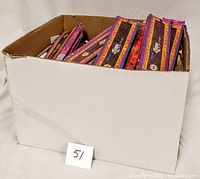 Full box view containing over 50 boxes of Satya incense sticks, showing storage and packaging state.