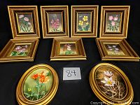 Nine framed oil paintings laid out on black background, seven rectangular and two oval