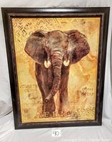Full front image of framed art print showing elephant and map in muted brown tones