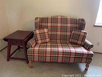 Broyhill loveseat and distressed oak drop leaf side table in room setting.
