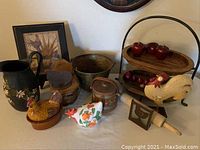 Full lot of country-themed kitchen and decorative items including ceramic chickens, painted pitcher, tiered server, framed artwork, rolling pin, and various containers.