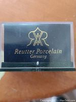 Close-up of the Reutter Porcelain mark label inside the shadow box