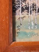 Close-up of silk painting signature and part of the nature scene with trees and a dog.