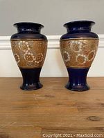 Pair of Royal Doulton vases side by side showing overall shape and design