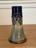 Full view of antique Royal Doulton bud vase showing overall color and shape