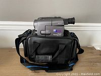 Full view of Sony Video8 Handycam camcorder inside its black carrying bag, showing front and side of the bag with strap.