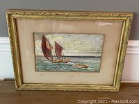 Full view of framed watercolor painting showing the sailboat with two red sails and smaller rowboat in water. Frame is decorative gold with visible age-related wear and staining on mat surrounding the painting.