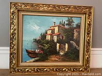 Framed Mediterranean coastal scene oil painting, showing overall view of artwork and frame with carved gold leaf motif.