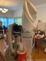 Full view of Delta filtration system mounted on wheeled cart with filter bag and hoses