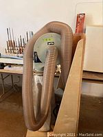 Delta dust collector unit with attached cloth filter bag and corrugated hose