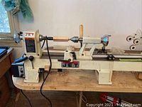 Front view of Jet wood turning lathe mounted on folding table showing headstock, tailstock, bed