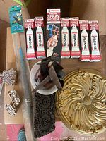 Arts and crafts tools including six boxed Pineval Spray System Power Units, a kite in packaging, paper art stamps, and decorative gold and black metal items