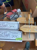 Photo showing Milwaukee jigsaw, Beall wood threaders boxes, and Rockler clamps on a table.