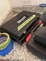 Black plastic Lignomat case labelled Lignomat