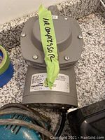 Photo of gray Thomas air compressor with label and 'Air Compressor' tape attached