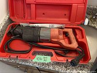 Milwaukee Sawzall reciprocating saw in red carrying case with power cord wrapped inside