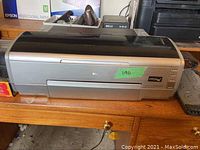 Silver Epson Stylus Photo 2200 wide-format printer on wooden desk