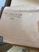 Envelope showing branding 'The Dirilyte Line' from Hand Industries Inc, Warsaw, Indiana.
