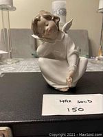 Front view of the Lladro angel figurine showing the peaceful seated pose and delicate facial details.