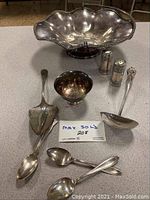 Photo showing complete lot with large serving bowl, salt and pepper shakers, small bowl, ladle, and spoons.