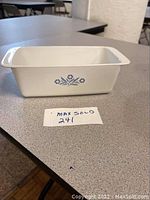 Front side view of white CorningWare loaf baking dish with blue floral design.