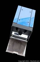 Front angled view of black and blue automatic watch winder showing the digital LCD display, four screws on top, and clear plastic protective door opened downward revealing the watch holder.