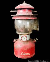 Front view of vintage red Coleman lantern showing overall condition and branding.