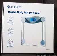 Photo of the ETEKCITY Digital Body Weight Scale box showing branding and product image with key features such as 400 lb / 180 kg capacity, immediate readings, and bright LCD display.
