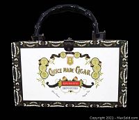 Front side of the pocketbook showing the Choice Made Cigar logo with gold medallions and detailed trim under the black bamboo-style handle.