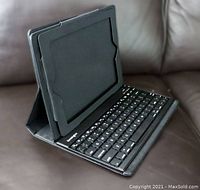 Side view of black Kensington tablet case holding keyboard, propped for use.