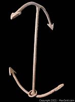 Full view of the vintage 4-point boat anchor showing the central shank, four pointed flukes, and rusted metal surface.