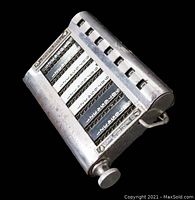 Top angle view showing metal body, seven chains with numbered digits, and large control knob.